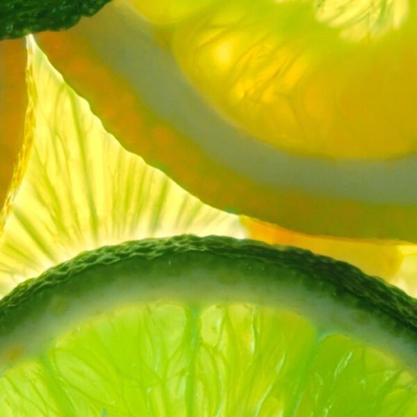 Lemon and green lime overlapped slices close-up background.